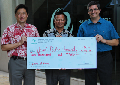UHA CEO Howard Lee gives Hawai‘i Pacific University’s Director of Development Kevin Takamori and Provost Matthew Liao-Troth a ceremonial check for $10,000 to benefit HPU’s College of Nursing and Health Sciences. Higher resolution photo available upon request.
