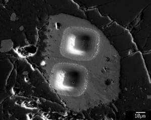 Image of pits left by microprobe analyses of a lunar apatite grain. Credit: KL Robinson, UH HIGP.