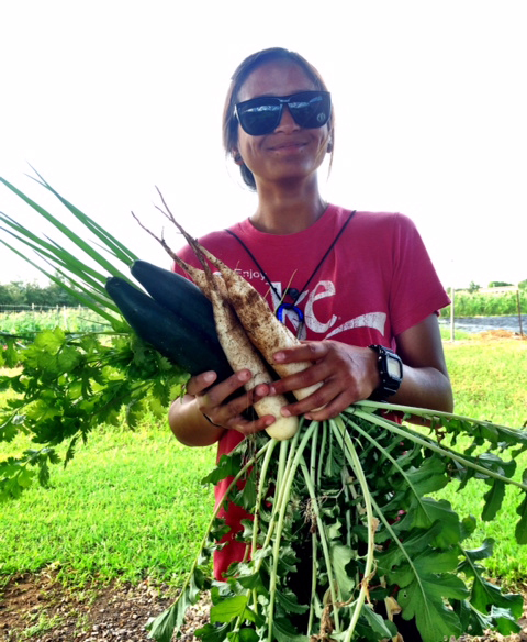 Hawai‘i Community College Agriculture student Chyane Kolish holds some of the vegetables grown by students in the class. Kolish and other Agriculture students donated 1,000 pounds of fresh produce to the Food Basket during the 2013-2014 academic year.