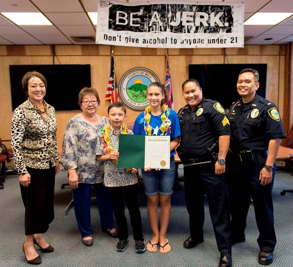 Tagline Winners Riley Regan and Kelly-Jo Molina (wearing leis) helped commemorate April as Alcohol Awareness Month by receiving a proclamation from Mayor Alan Arakawa. The youth are joined by (L-R) Yuki Lei Sugimura, community organizer; Jan Shishido, Deputy Director, Dept. of Housing and Human Concerns; MPD Sgt. Audra Sellers; and MPD Lt. William Juan. CREDIT: County of Maui / Ryan Piros
