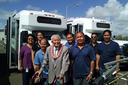 Native Hawaiian kupuna “Uncle” Thomas Takahashi and some of the Transportation Agency staff gather following the blessing last week of 20 new buses. From L to R: Rosie Rapozo; Celia Mahikoa; Clem Correira; Takahashi; Derrick Leanio; Irineo Soriano and Richard Raralio.