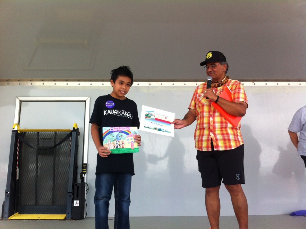 Aljhay Flores, a fourth grade student at King Kaumuali‘i Elementary School and first runner up, proudly displays his award-winning art work.